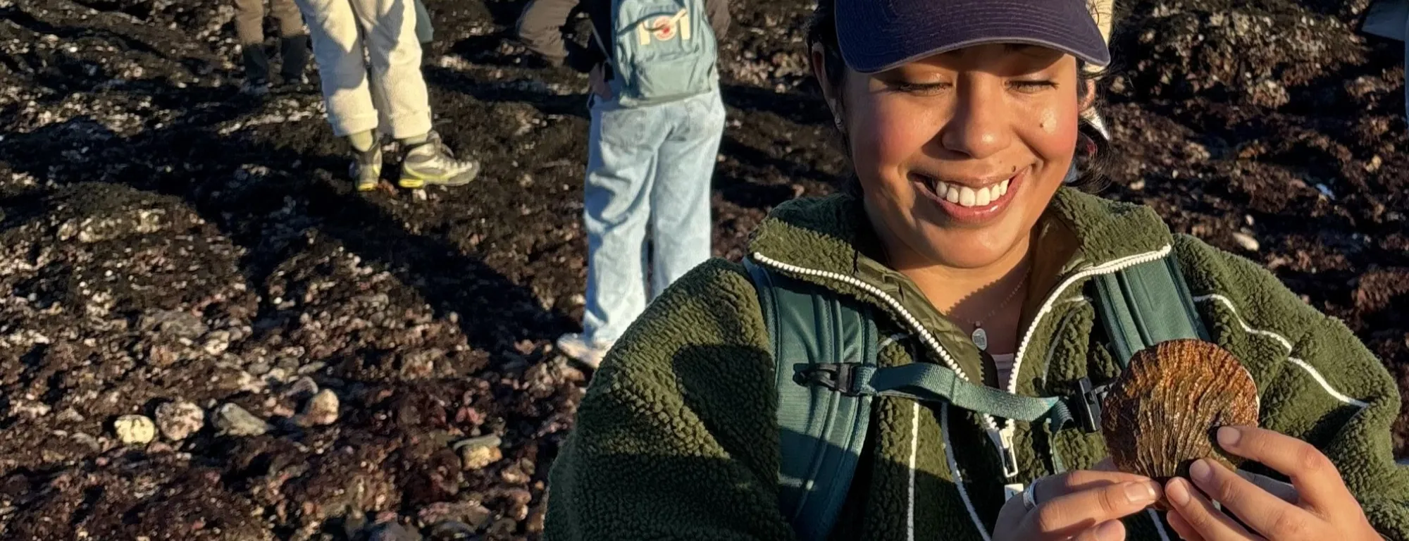 Daisy Prado holds a shell as she explores Duxbury Reef as part of a UC California Naturalist course excursion