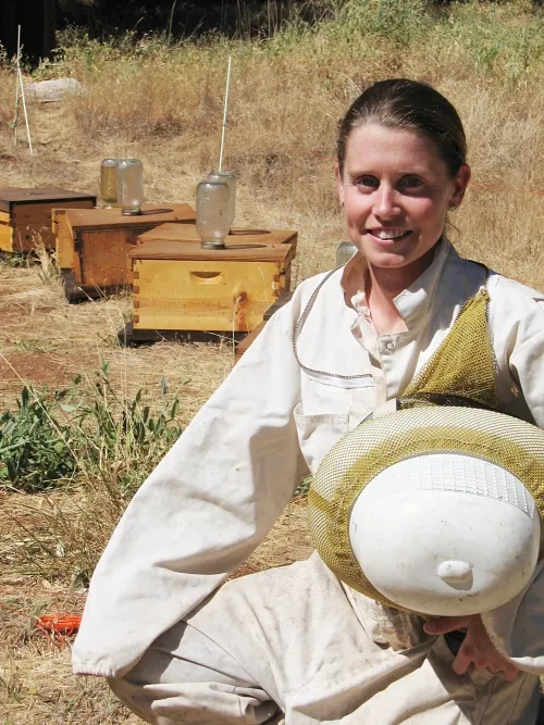 Michelle Flenniken next to Grass Valley hives. (Photo by Kim Fondrk)