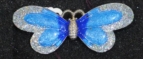 BUTTERFLY JEWELRY--Does life imitate art or art imitate life? This butterfly pin at the Entomological Society of America's recent meeting in Reno looked somewhat like the live butterflies inside a nearby display. (Photo by Kathy Keatley Garvey)