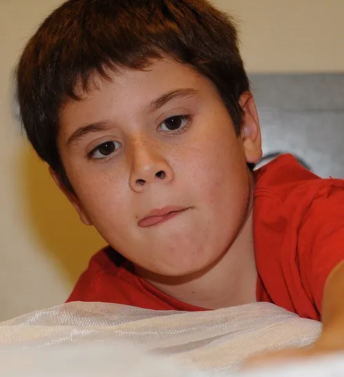YOUNG SCIENTIST--Eleven-year-old Gabriel Leal of Davis works on his science project in which he found that the navel orangeworm prefers pistachios over almonds and walnuts. (Photo by Kathy Keatley Garvey)
