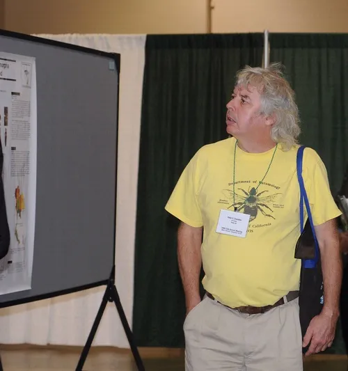 UC DAVIS ENTOMOLOGIST Peter Cranston looks over posters at the Entomological Society of America meeting, held recently in Reno. He and colleague Penny Gullan are now finishing the fourth edition of their textbook, "The Insects." (Photo by Kathy Keatley Garvey)