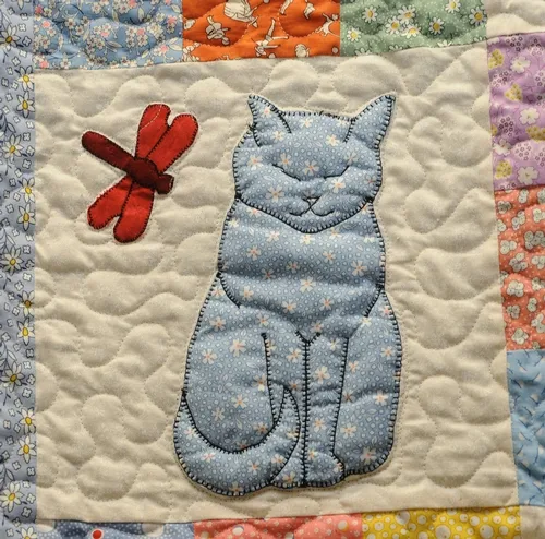 A DRAGONFLY meets a cat in this quilt made by Helen McNaughton of Dixon. It's on display at the May 7-10 Dixon May Fair. (Photo by Kathy Keatley Garvey)