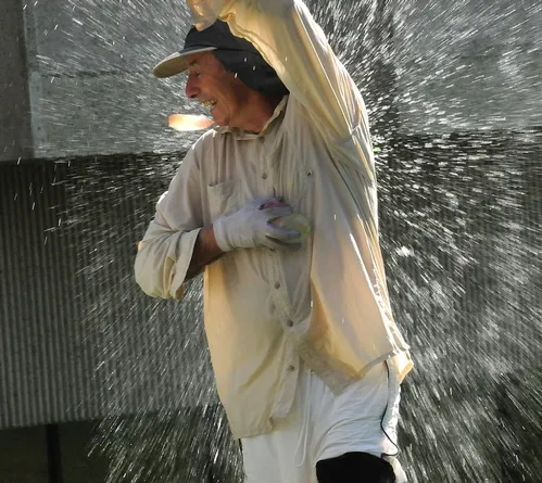 GOTCHA! Bruce Hammock is hit by a water ballon. When the water warriors deplete their supply of water balloons, they turn to tubs and buckets. (Photo by Kathy Keatley Garvey)
