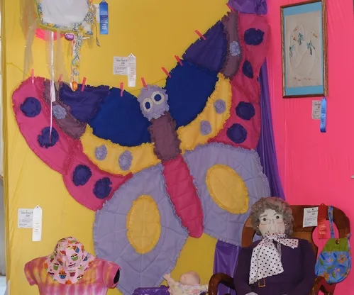 COLORFUL BUTTERFLY QUILT, the work of longtime 4-H volunteer Linda Douthit of Fairfield, decorates a corner of McCormack Hall at the Solano County Fair, Vallejo. (Photo by Kathy Keatley Garvey)