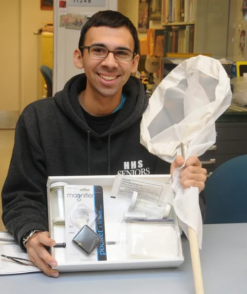 UC DAVIS entomology major Joel Hernandez, a student assistant at the Bohart Museum of Entomology, shows one of the insect collection kits available in the gift shop. Martha Stewart listed the Bohart Museum insect collection kit as one of the top three gifts to get young naturalists. Hernandez acquired one at age 7. (Photo by Kathy Keatley Garvey)