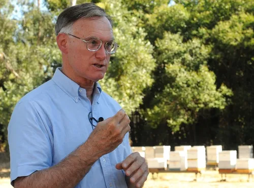 HONEY BEE GURU Eric Mussen receives news media calls from all over the world. Here he's in front of hives at the Harry H. Laidlaw Jr. Honey Bee Research Faciity. (Photo by Kathy Keatley Garvey)