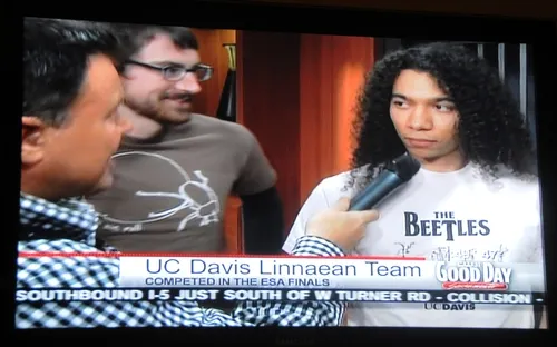 TV ANCHOR Mark Mathias (left) quizzes Ralph Washington (right) about Madagascar hissing cockroaches. Next to him is Andrew Merwin. (Photo of Good Day Sacramento TV screen by Kathy Keatley Garvey)