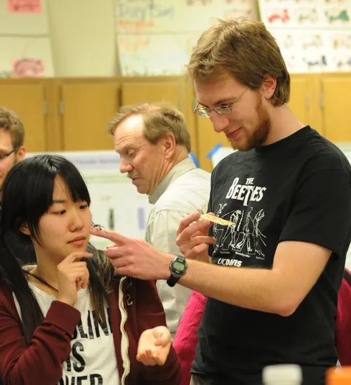 SARAH HAN, who works in the Greg Lanzaro lab at UC Davis and plans to enter entomology graduate school, meets a thorny walking stick from Borneo. With her is UC Davis entomology graduate student Matan Shelomi, who studies with major professor Lynn Kimsey, director of the Bohart Museum of Entomology. (Photo by Kathy Keatley Garvey)