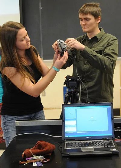 JAMES HARWOOD (right), who webcasts many of the UC Davis Department of Entomology seminars, served on the winning Linnaean team with teammates Emily Symmes, Matan Shelomi and Meredith Cenzer. Here he and graduate student Amy Morice set up a camera for a webcast. Both study with major professor James R. Carey. (Photo by Kathy Keatley Garvey)