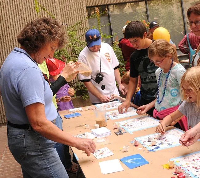 Entomologist/artist Diane Ullman (left) at work with Maggot Art. (Photo by Kathy Keatley Garvey)