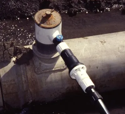 Pre-set pressure-regulating valve at the head of a drip tape lateral line. Photo: L. Schwankl.