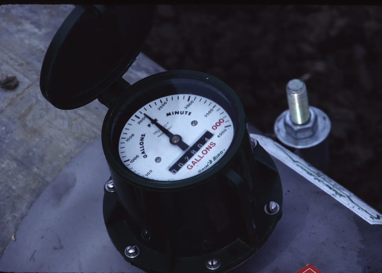 Saddle-mount propeller meter installed at the head of a drip system. Note the instantaneous (gpm) and totalizing (gal) registers. Photo: L. Schwankl.
