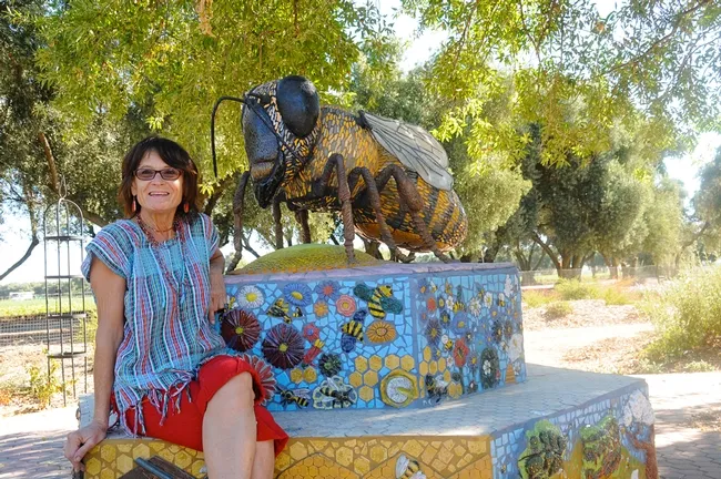 Artist-scientist Donna Billick with her sculpture of "Miss Bee Haven" at the Haagen-Dazs Honey Bee Haven on Bee Biology Road, UC Davis. (Photo by Kathy Keatley Garvey)