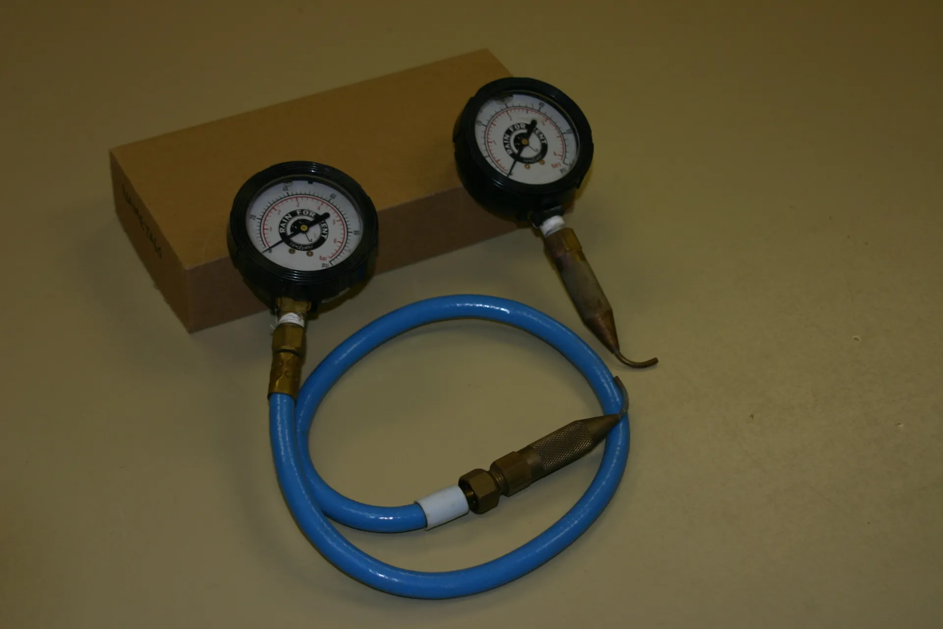 Pressure gauges with attached pitot tubes for measuring pressure inside drip tubing. Photo: L. Schwankl.