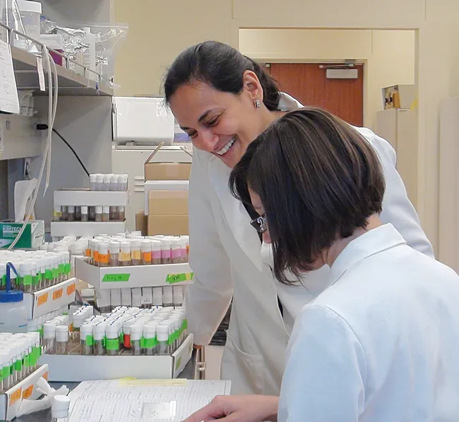 Molecular neurobiologist Anupama Dahanukar of UC Riverside working with Drosophila cultures with junior specialist, Adriana Medina.