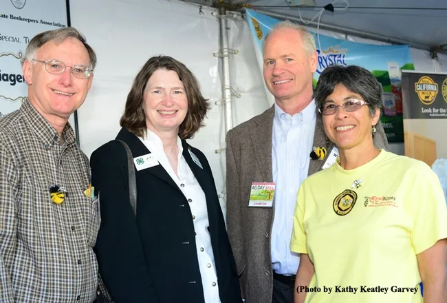 Say "Honey!" From left are Extension apiculturist Eric Mussen of UC Davis; Barbara Allen-Diaz, vice president of UC ANR; Bill Lewis, president of the California State Beekeepers' Association; and Marti Ikehara of the Sacramento Area Beekeepers' Association. (Photo by Kathy Keatley Garvey)