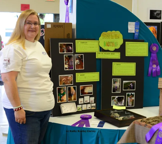 Sharon Payne, superintendent of the Today's Youth Building at the Dixon May Fair, stands by a 6-year-old's bug exhibit, which won a blue ribbon and best of show. (Photo by Kathy Keatley Garvey)