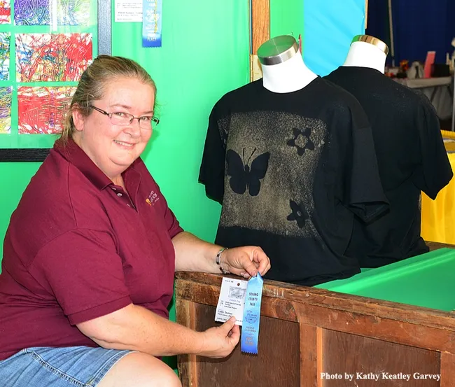 McCormack Hall assistantSharon Payne with "Butterfly T-Shirt" by Leslie Dunham of PACE Solano. (Photo by Kathy Keatley Garvey)