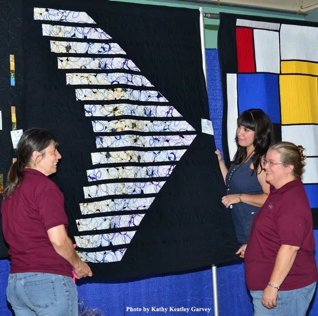 Hanging "Flying Wing" are (from left) Gloria Gonzalez, Angelina Gonzalez (back) and Sharon Payne. (Photo by Kathy Keatley Garvey)