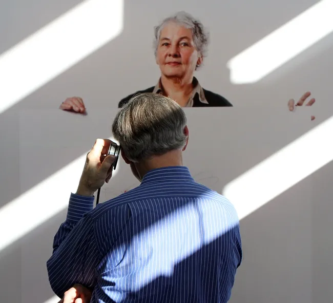 Extension apiculturist (emeritus) Eric Mussen of the UC Davis Department of Entomology and Nematology, stops to listen to a recording about Christiane Nüsslein-Volhard.