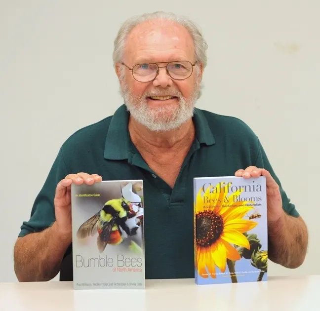 Native pollinator specialist Robbin Thorp, distinguished emeritus professor of entomology at UC Davis, with two of the books he co-authored in 2014. He is an associate at the Bohart Museum. (Photo by Kathy Keatley Garvey)