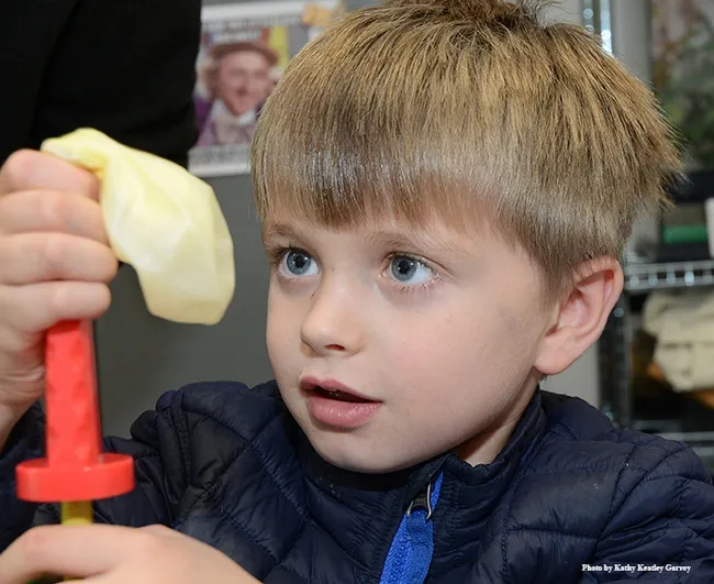 Ethan Fry, 5, of Davis, inflates a balloon at the "parasitoid" balloon station. (Photo by Kathy Keatley Garvey)