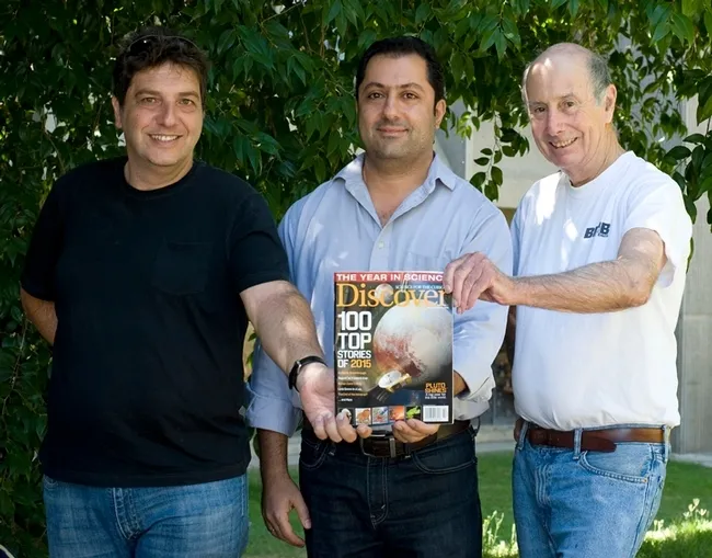 Holding a copy of Discover magazine's edition of "The Top 100 Science Stories of 2015," are (from left) UC Davis researchers Bora Inceoglu, Fawaz Haj and Bruce Hammock. (Photo by Kathy Keatley Garvey)