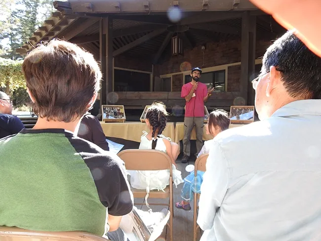 Entomologist Joel Hernandez discusses butterflies and moths. In the background are some of his specimens. (Photo by Kathy Keatley Garvey)