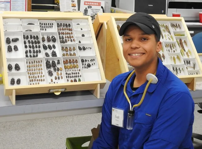 Noah Crockette, 17, of Davis, participated on the Belize tour and answered questions from the crowd at the Bohart open house. He won a grant to study beetles in Belize. (Photo by Kathy Keatley Garvey)