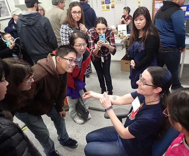 Nematologist/parasitologist Lauren Camp, who received her doctorate at UC Davis last December, volunteered for the bed bug-feeding demonstration. (Photo by Kathy Keatley Garvey)