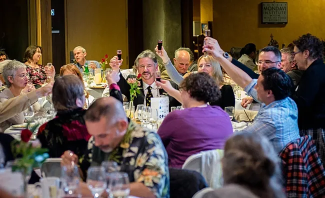 This was the scene at the UC Davis Honey and Pollination Center's 2016 Feast. At right (glasses, facing camera) is pollinator ecologist Neal Williams, associate professor of entomology, UC Davis Department of Entomology and Nematology. In the foreground (in purple and blue) are Extension apiculturist Elina Niño and Bernardo Niño of the Harry H. Laidlaw Jr. Honey Bee Research Facility. (Photo by Mick’s Magic Moments)