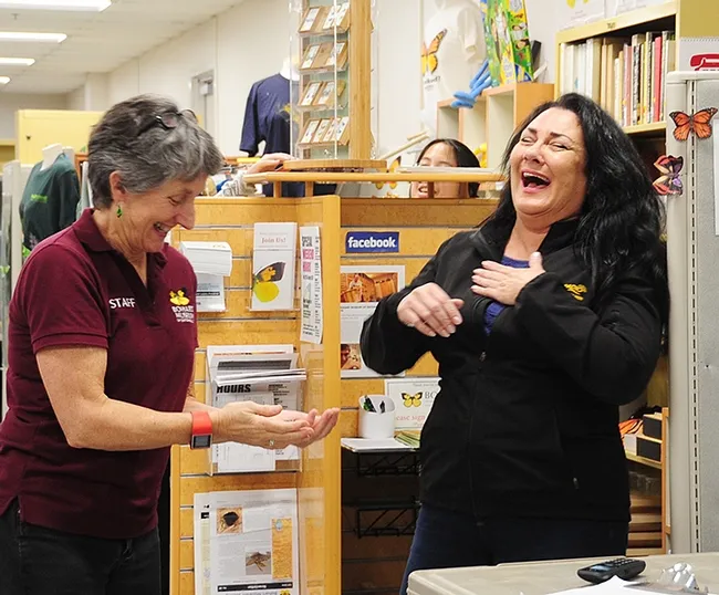 Oh, no, an escapee! Lynn Kimsey (left), director of the Bohart Museum of Entomology and KUIC host Barbara Hoover share a laugh as a Madagascar hissing cockroach decides not to star but to escape. (Photo by Kathy Keatley Garvey)