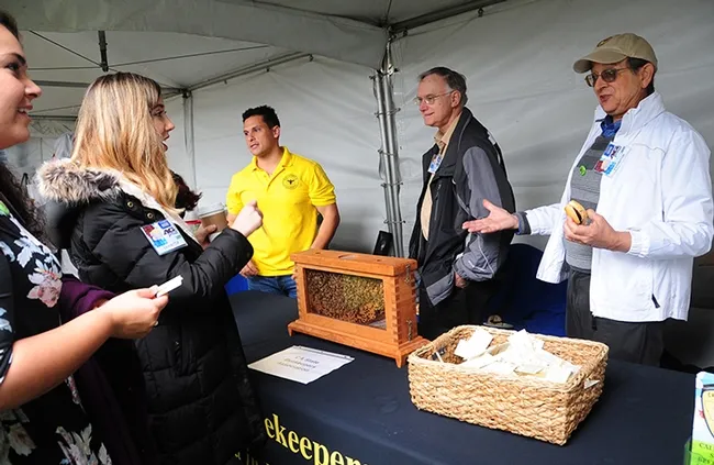 Staffing the CSBA booth and answering questions about bees are (from left) Bernardo Niño of the E. L. Niño Lab, Harry H. Laidlaw Jr. Honey Bee Research Facility, UC Davis Department of Entomology and Nematology; Eric Mussen, California Extension apiculturist emeritus, UC Davis Department of Entomology and Nematology; and Carlen Jupe, CSBA treasurer. (Photo by Kathy Keatley Garvey)