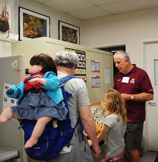 Entomologist and Bohart Museum associate Jeff Smith talks butterflies to Ted Swift and his daughter Grace Swift, 10, of Davis.