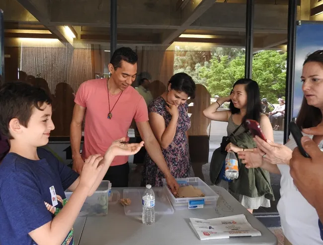 Entomology graduate student Ralph Washington Jr., holds forth as "The Bug Doctor." The doctor was always in, from 10 a.m. to 4 p.m.