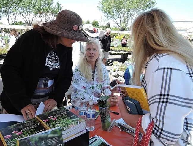 Following her talk at Annie's Annuals and Perennials, Richmond, Kate Frey (center) answers questions and signs copies of her book,"The Bee Friendly Garden" (co-authored with Professor Gretchen LeBuhn of San Francisco State University). (Photo by Kathy Keatley Garvey)