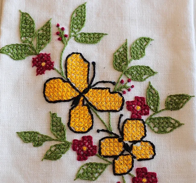 Hand embroidered needlework, intricate work by Laura Ryan, Vallejo, is displayed at McCormack Hall. (Photo by Kathy Keatley Garvey)