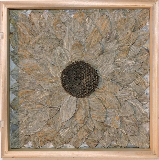 This is part of the trilogy of wall pieces created by artist Ann Savageau, professor emerita, UC Davis Department of Design. Her materials: hornet nest paper.