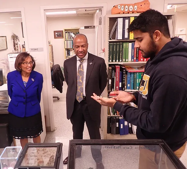 UC Davis entomology student and Entomology Club secretary Lohit Garikipati, introduces Martha, an adult orchid mantis, Hymenopus coronatus, to UC Davis Chancellor Gary May and Dean Helene Dillard of the College of Agricultural and Environmental Sciences. (Photo by Kathy Keatley Garvey)