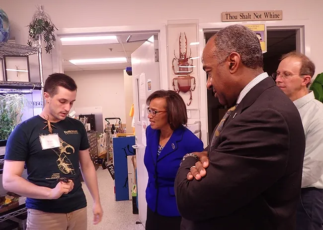 UC Davis entomology student and Bohart associate Wade Spencer shows Hamilton, his scorpion, to Dean Helene Dillard of the College of Agricultural and Environmental Sciences, UC Davis Chancellor Gary May and Steve Nadler (far right), chair of the UC Davis Department of Entomology and Nematology. (Photo by Kathy Keatley Garvey)