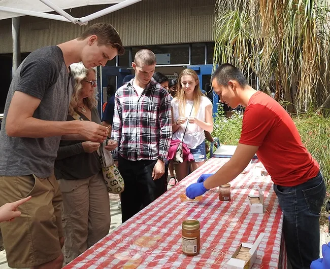 Entomology graduate student Yao Cai (right) of the Joanna Chiu lab helped staff the honey tasting table at Briggs Hall during the 2017 UC Davis Picnic Day. (Photo by Kathy Keatley Garvey)