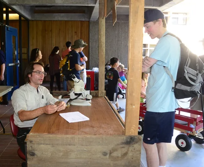 Doctoral candidate Brendon Boudinot of the UC Davis Department of Entomology and Nematology fields a question from a "client" at the Bug Doctor booth at the 104th annual UC Davis Picnic Day. (Photo by Kathy Keatley Garvey)