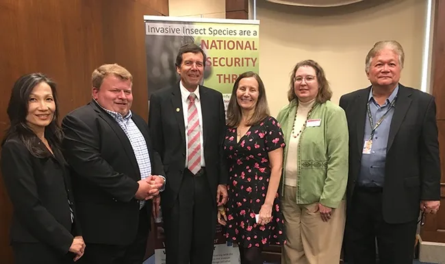 The panel gathers for a group photo following the congressional briefing. From left are Faith Oi, University of Florida; Lee Van Wychen, Weed Science Society of America; moderator Frank Zalom of UC Davis Department of Entomology and Nematology and a past president of the Entomological Society of America; Paula Shrewsbury of the University of Maryland; Kelley Tilmon of Ohio State University; and Dave Chun, chief of staff for Rep. Tulsi Gabbert. (Photo by Chris Stelzig)