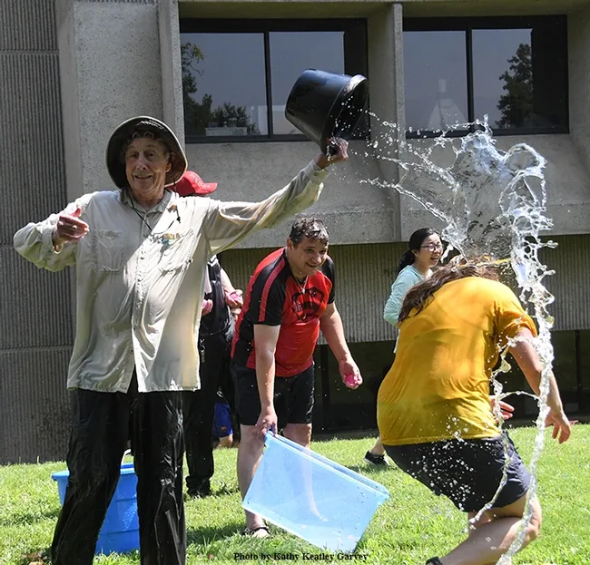 Proving himself an elite water warrior, Bruce Hammock nonchalantly empties a bucket of water on his doctoral student, Cindy McReynolds. "I thought I dodged it," she later said. She did not. (Photo by Kathy Keatley Garvey)