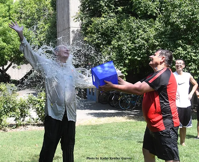 Gotcha! Hammock lab researcher Christopher Morisseau (right), who coordinates the annual Bruce Hammock Lab Water Balloon Battle, scores a direct hit! Bruce Hammock smiles. (Photo by Kathy Keatley Garvey)