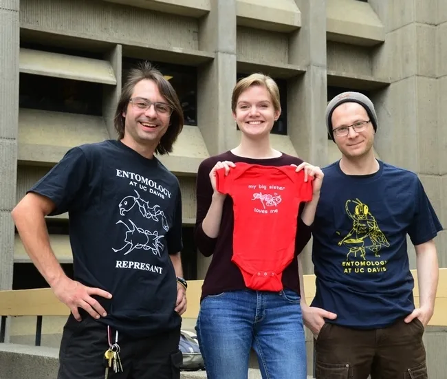 EGSA members and their award-winning t-shirts: president Brendon Boudinot; EGSA t-shirt coordinator Jill Oberski; and Corwin Parker. (Photo by Kathy Keatley Garvey)