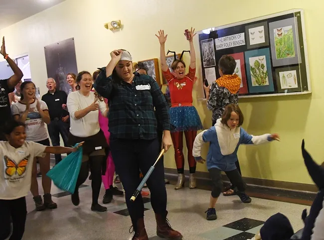 The exact moment: we have a winner! Emma Cluff removes her mask as the crowd applauds her victory. (Photo by Kathy Keatley Garvey)