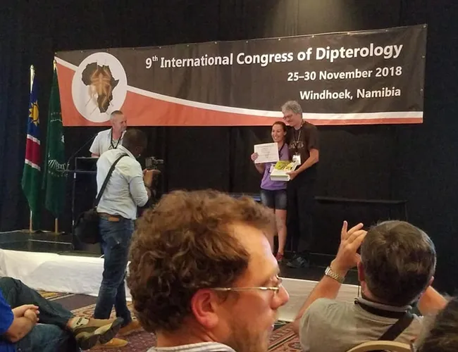 Professor Thomas Pape of the Natural History Museum of Denmark and chair of the Council for the International Congresses of Dipterology, presents the top student prize to Jessica Gillung. The next Congress takes place in 2022 in California.