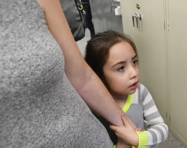 Kira Olmos, 5, of Winters isn't sure she wants meet an Australian stick insect at the Bohart Museum. She is holding mom's hand. (Photo by Kathy Keatley Garvey)