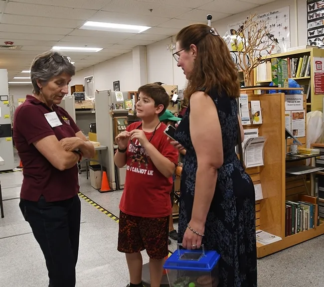Delsin Russell of Vacaville, then 8, attended an open house last August at the Bohart Museum of Entomology with his mother, Beth. Here they chat with Lynn Kimsey, director of the Bohart Museum and professor of entomology at UC Davis. (Photo by Kathy Keatley Garvey)